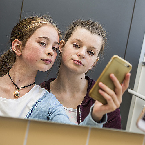 Zwei jugendliche Mädchen machen ein Selfie.
